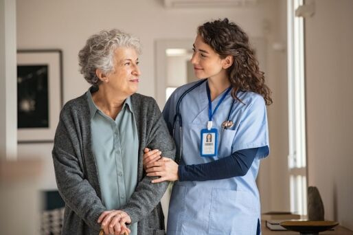 Senior woman and healthcare team member at a senior living community.